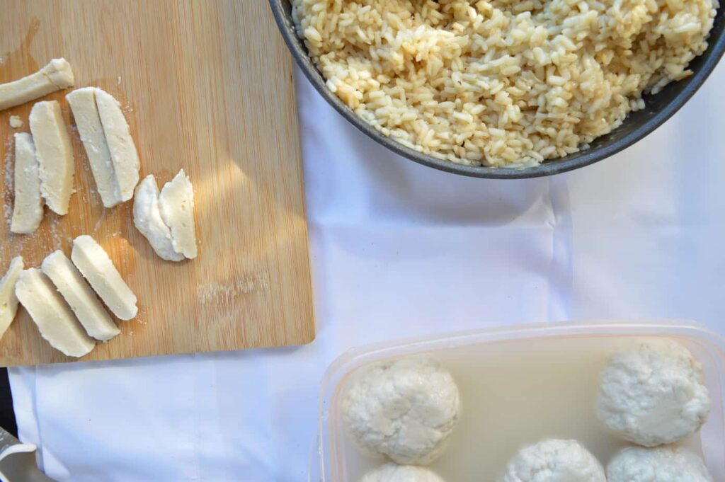 vegan Mozzarella on wooden chopping boards and a bowl of risotto c