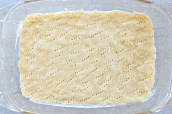 a bottom layer of shortcrust pastry in a glass dish