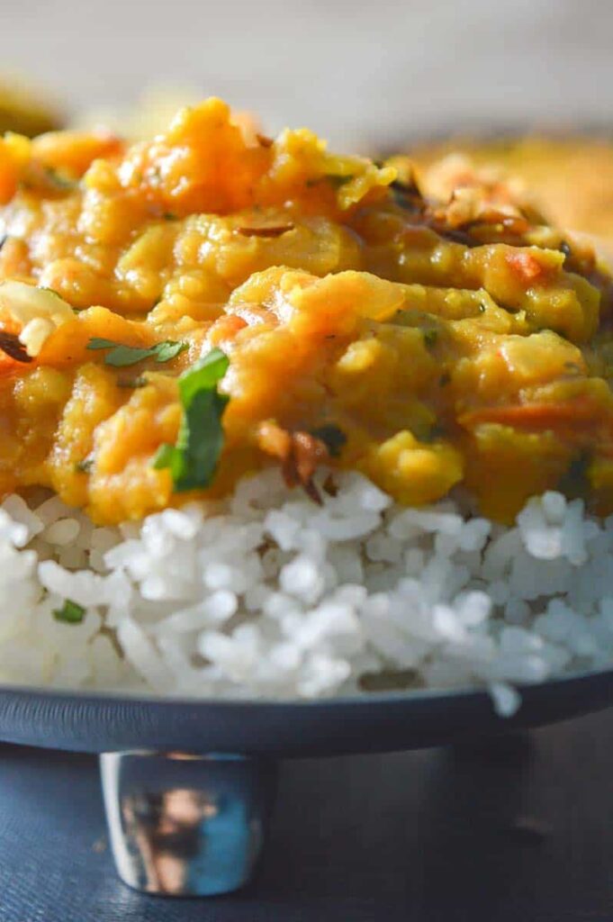 Yellow Indian lentil curry piled on top of white basmati rice