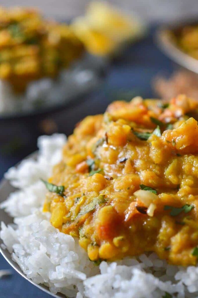Yellow lentil curry served over white rice