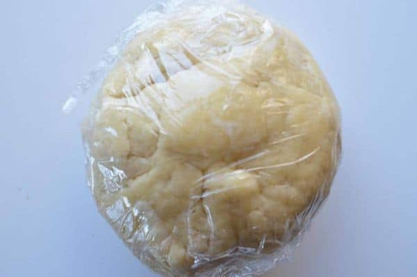 A ball of dough wrapped in cling film