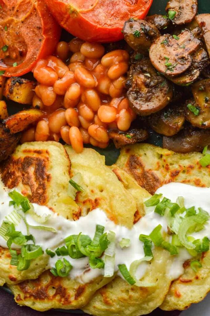 A vegan version of a full Irish breakfast (tomatoes, mushrooms, baked beans, tomatoes and boxty)