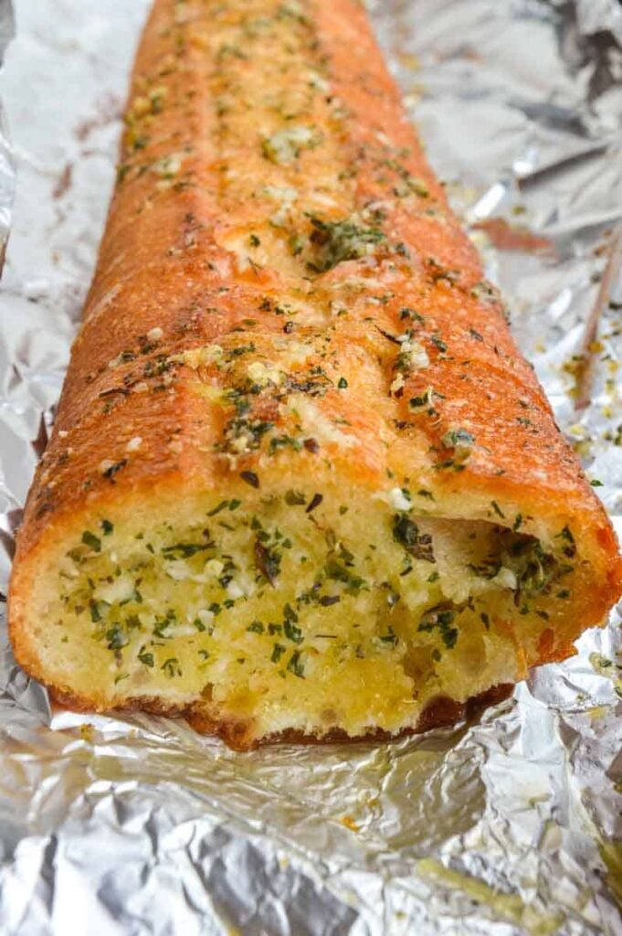 A cut baguette with garlic butter mix