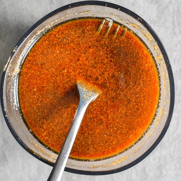 Bowl with a fork resting in the sauce ready for frying