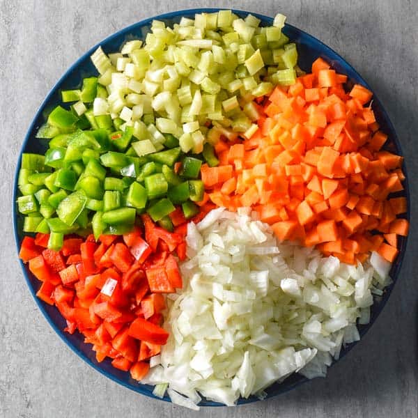 Blue plate with diced celery, carrots, onion, and green and red pepper
