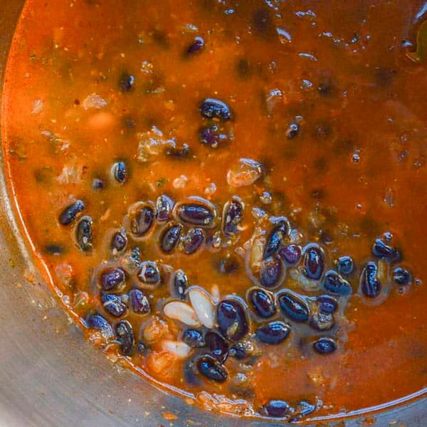 Black beans and red stock in a pot