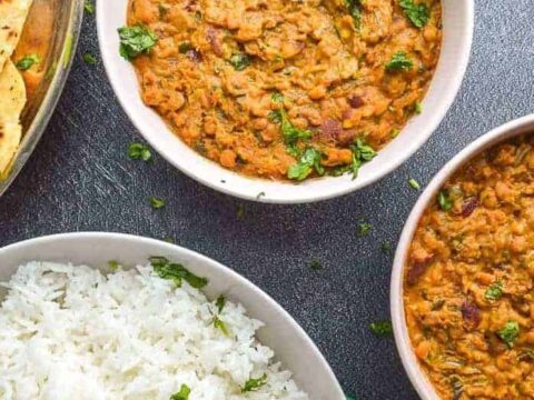 Two bowls of creamy lentils and a big bowl of rice