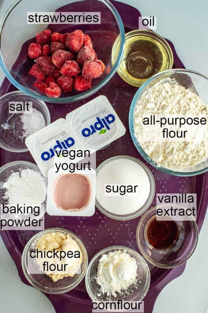 labelled ingredients for vegan strawberry cake, including flour, sugar, vegan yogurt, baking powder, chickpea flour, vanilla extract