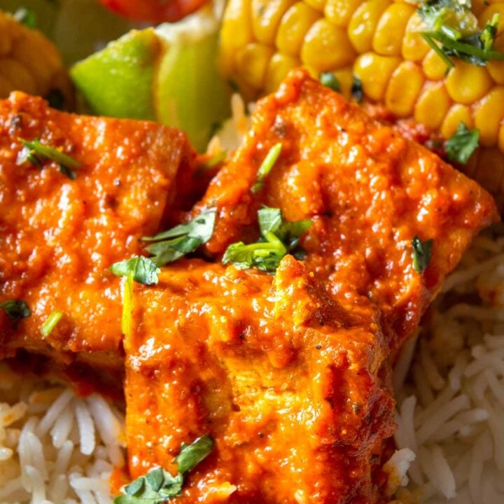 Close up of tofu with a thickened orange sauce