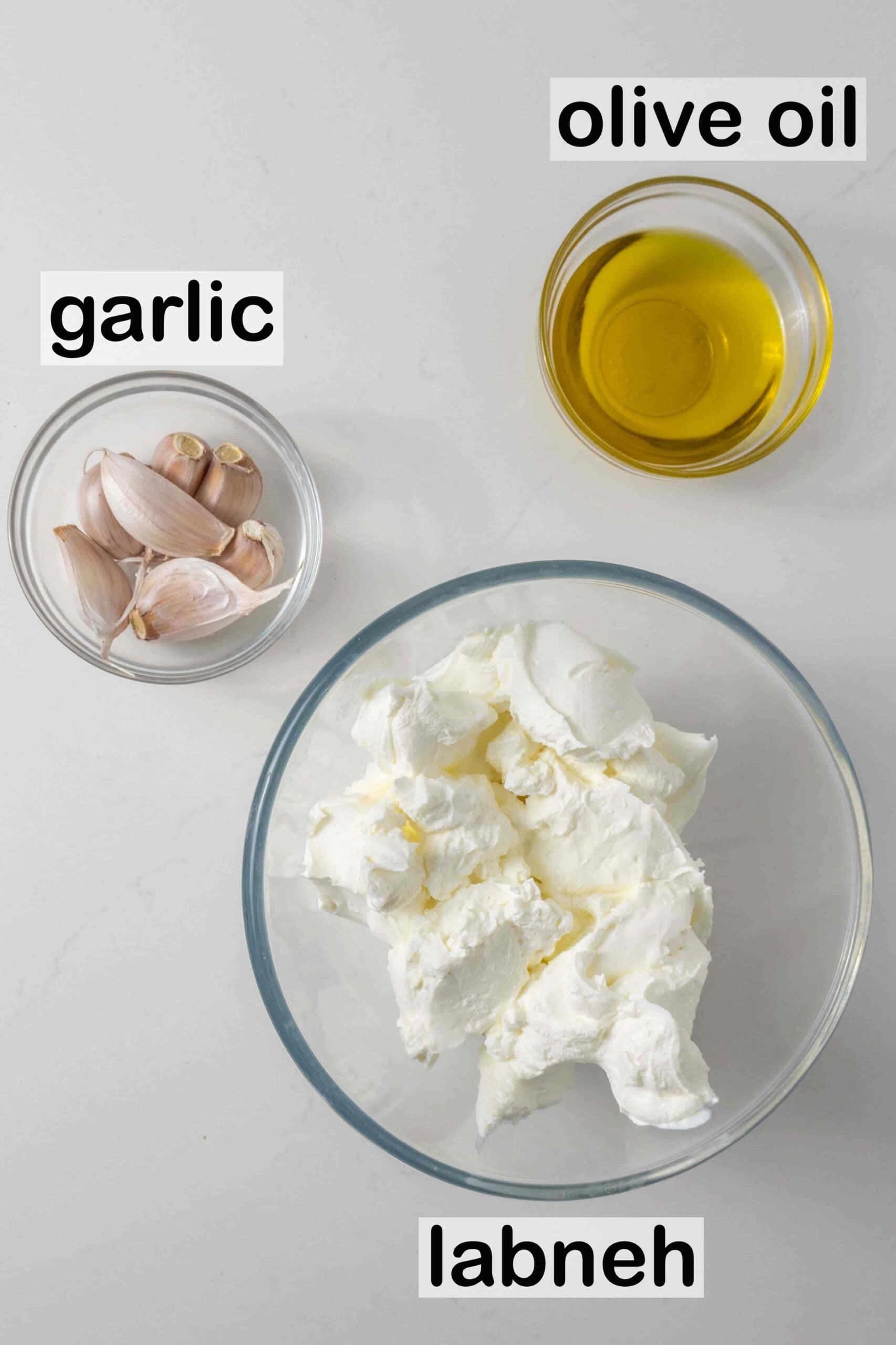 3 glass bowls with olive oil, garlic and labneh.